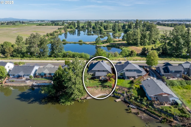 birds eye view of property with a water view and a residential view