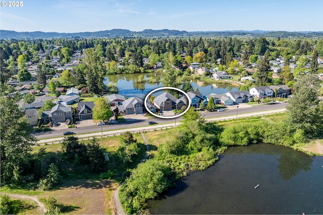 aerial view featuring a water and mountain view and a residential view