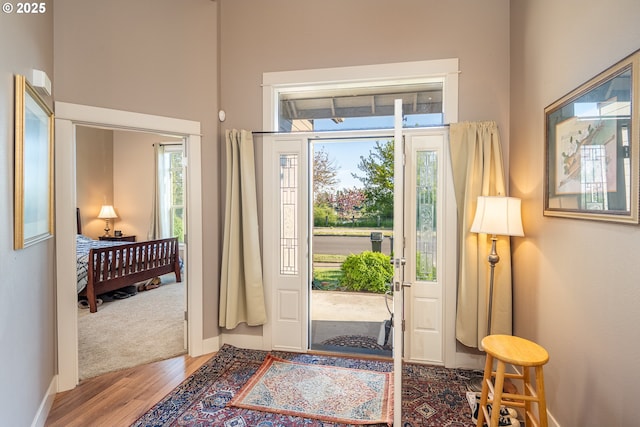 interior space with baseboards and wood finished floors