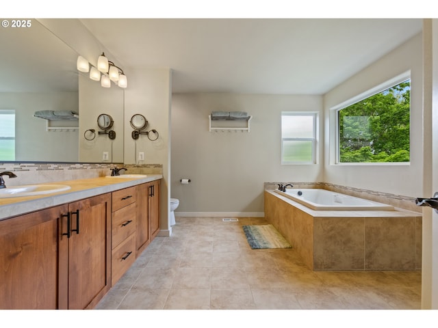 full bath featuring tile patterned flooring, double vanity, toilet, a bath, and a sink
