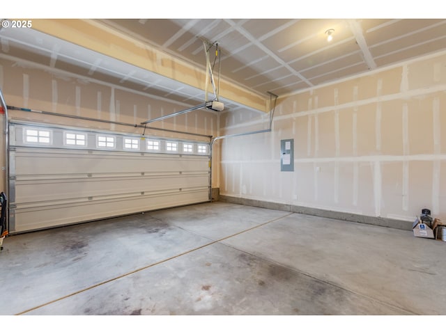 garage with a garage door opener and electric panel