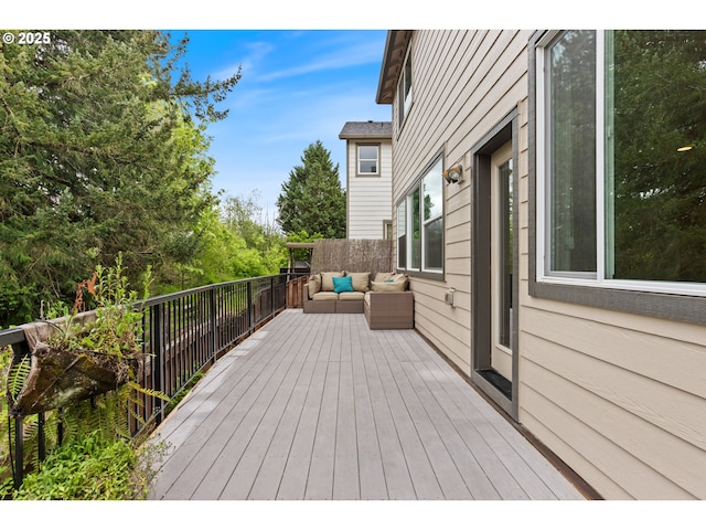 wooden terrace featuring outdoor lounge area