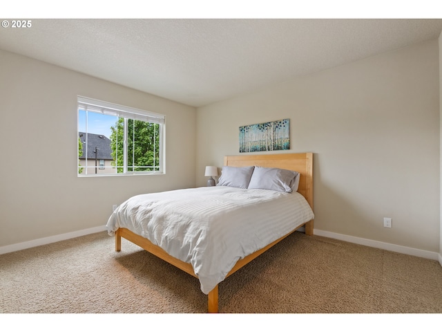 bedroom with baseboards and carpet flooring