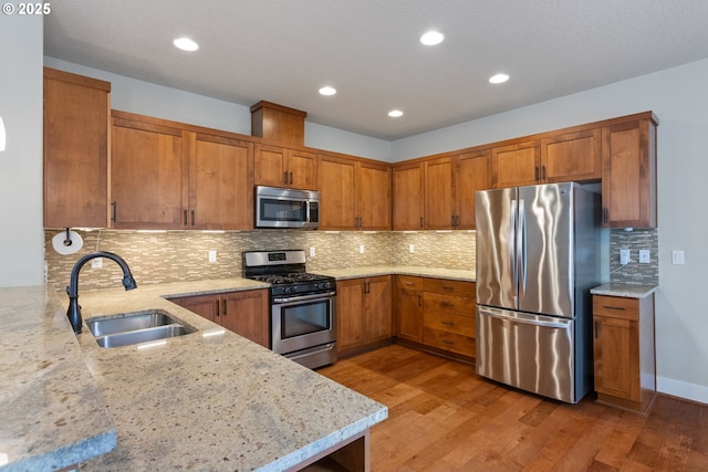 20317 SW Gracie St, Beaverton, OR 97006 - kitchen featuring a sink, stainless steel appliances, and brown cabinets