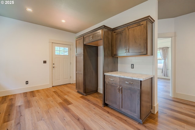 7906 SE Woodstock Blvd, Portland, OR 97206 - kitchen with light wood-style flooring, baseboards, light countertops, backsplash, and recessed lighting