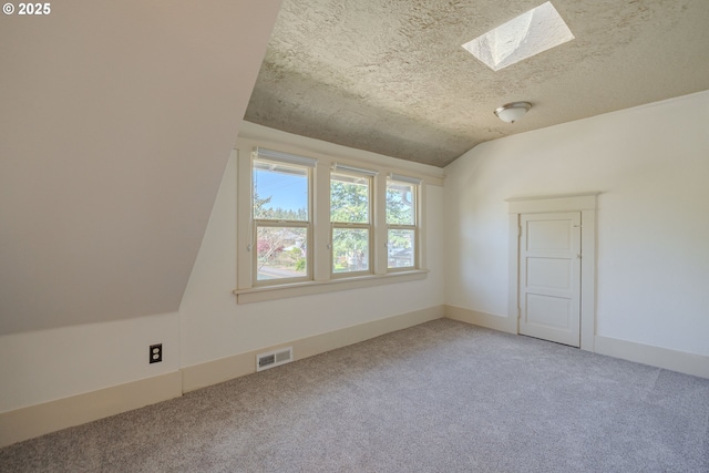 7906 SE Woodstock Blvd, Portland, OR 97206 - bonus room featuring carpet floors, a skylight, lofted ceiling, and a textured ceiling