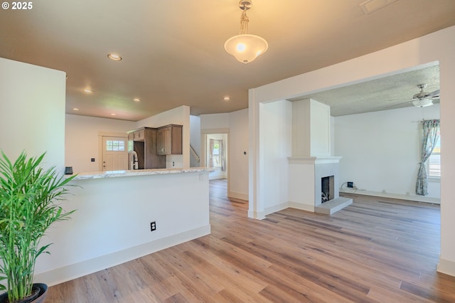 7906 SE Woodstock Blvd, Portland, OR 97206 - kitchen with light wood-style floors, a ceiling fan, open floor plan, baseboards, and recessed lighting
