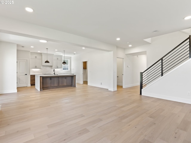 1208 N 44th Pl, Ridgefield, WA 98642 - unfurnished living room featuring recessed lighting, baseboards, and stairway