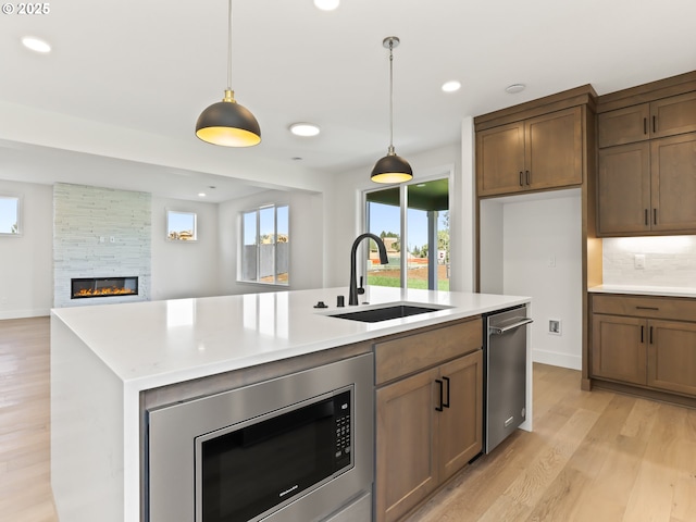 1208 N 44th Pl, Ridgefield, WA 98642 - kitchen with appliances with stainless steel finishes, a sink, light countertops, light wood finished floors, and recessed lighting