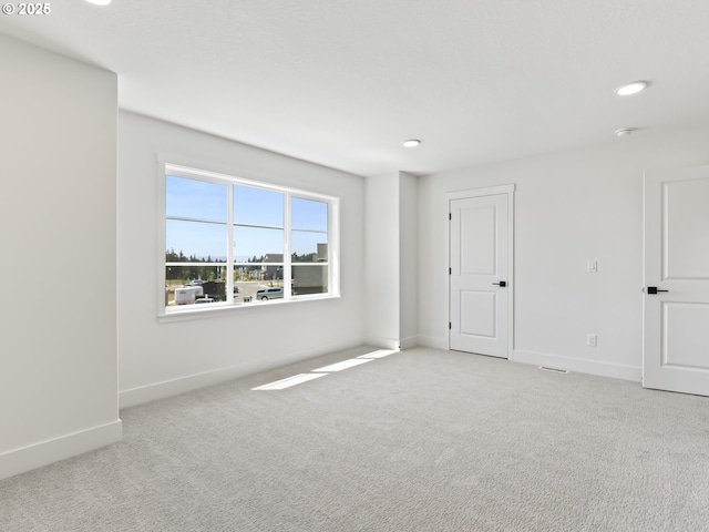 1208 N 44th Pl, Ridgefield, WA 98642 - empty room featuring baseboards, recessed lighting, and light colored carpet