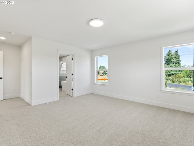 1208 N 44th Pl, Ridgefield, WA 98642 - unfurnished room featuring baseboards, a wealth of natural light, and light colored carpet