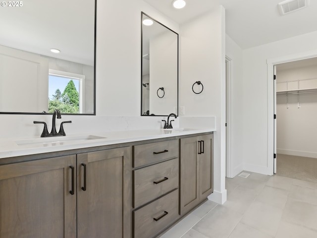 1208 N 44th Pl, Ridgefield, WA 98642 - full bathroom with visible vents, a sink, baseboards, and double vanity