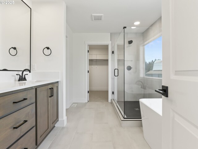 1208 N 44th Pl, Ridgefield, WA 98642 - bathroom with visible vents, vanity, baseboards, a spacious closet, and a stall shower