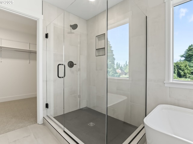 1208 N 44th Pl, Ridgefield, WA 98642 - full bathroom featuring a freestanding tub, a spacious closet, plenty of natural light, and a stall shower