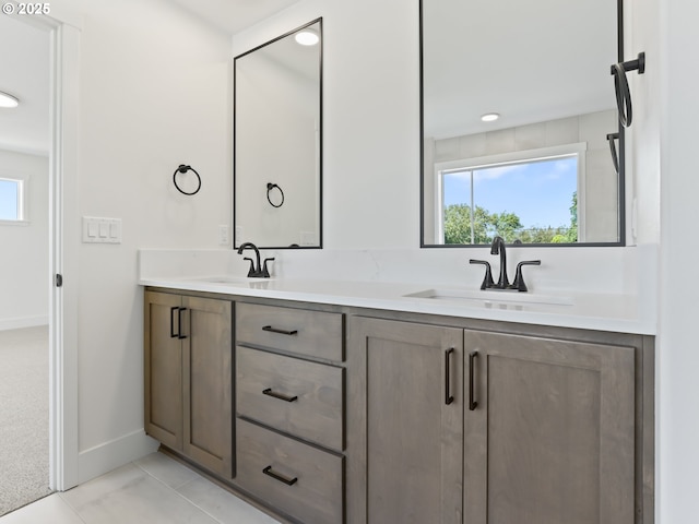 1208 N 44th Pl, Ridgefield, WA 98642 - bathroom with double vanity, baseboards, and a sink