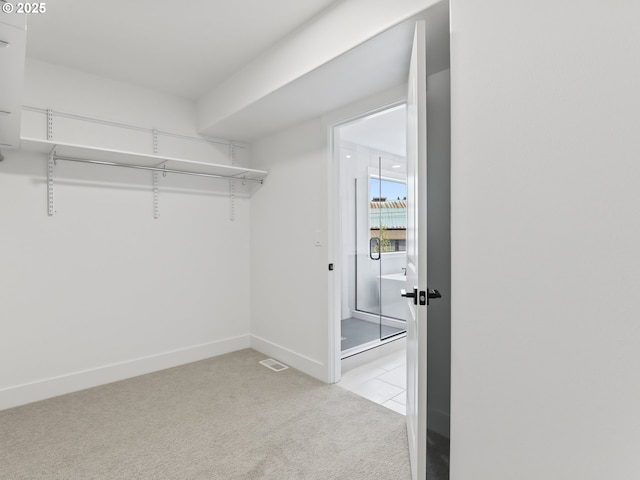 1208 N 44th Pl, Ridgefield, WA 98642 - walk in closet featuring light tile patterned floors, visible vents, and light colored carpet