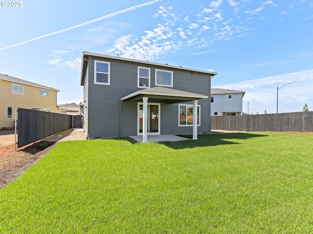 1208 N 44th Pl, Ridgefield, WA 98642 - rear view of property with a lawn, a patio, and a fenced backyard