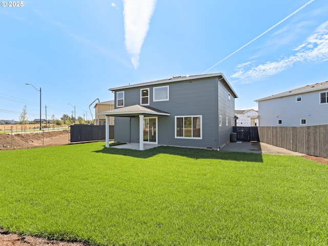 1208 N 44th Pl, Ridgefield, WA 98642 - rear view of property featuring a patio, a fenced backyard, and a lawn