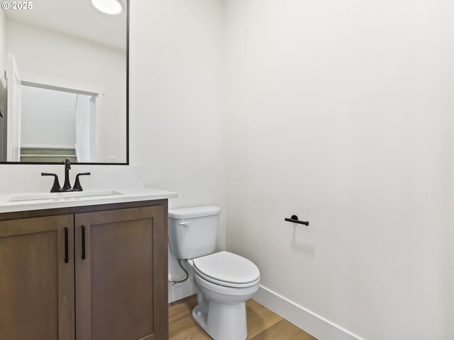 1208 N 44th Pl, Ridgefield, WA 98642 - half bath with toilet, baseboards, wood finished floors, and vanity