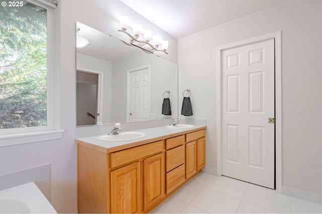 bathroom with tile patterned flooring, vanity, and a chandelier