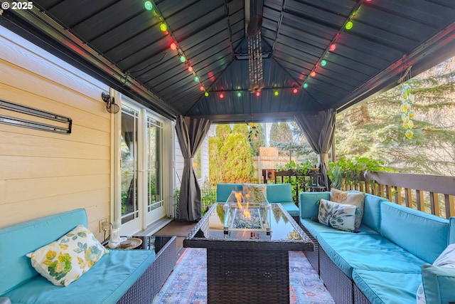 view of patio with a gazebo and an outdoor living space with a fire pit