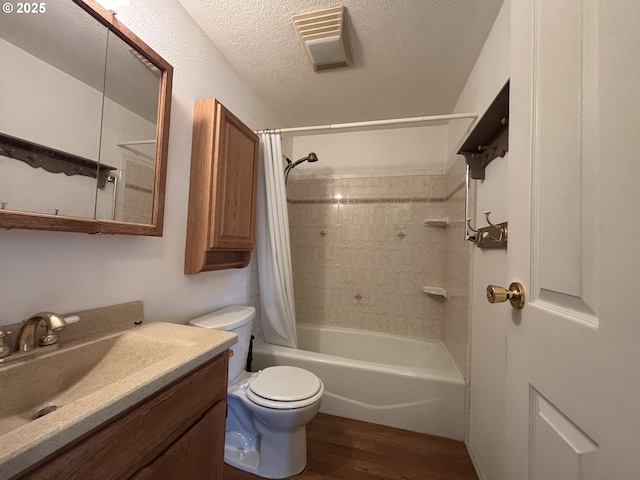 2312 N Pine St, La Grande, OR 97850 - bathroom with wood finished floors, shower / bath combination with curtain, vanity, and a textured ceiling