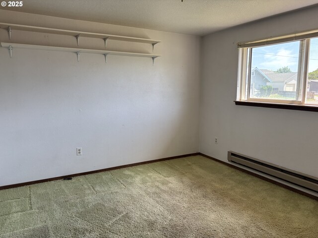 2312 N Pine St, La Grande, OR 97850 - unfurnished room featuring baseboard heating and light colored carpet