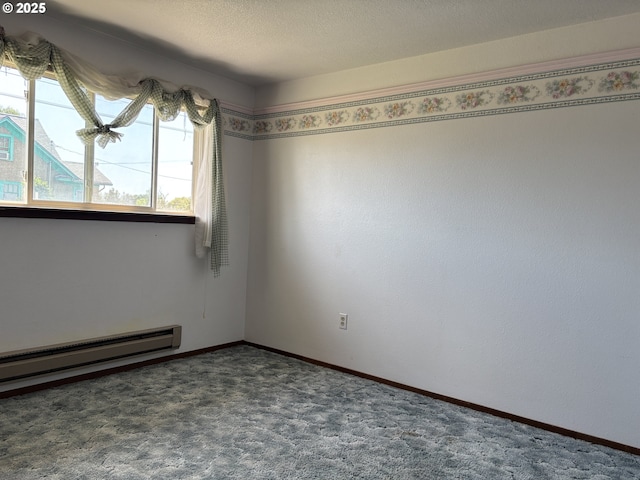 2312 N Pine St, La Grande, OR 97850 - carpeted empty room featuring baseboard heating and baseboards