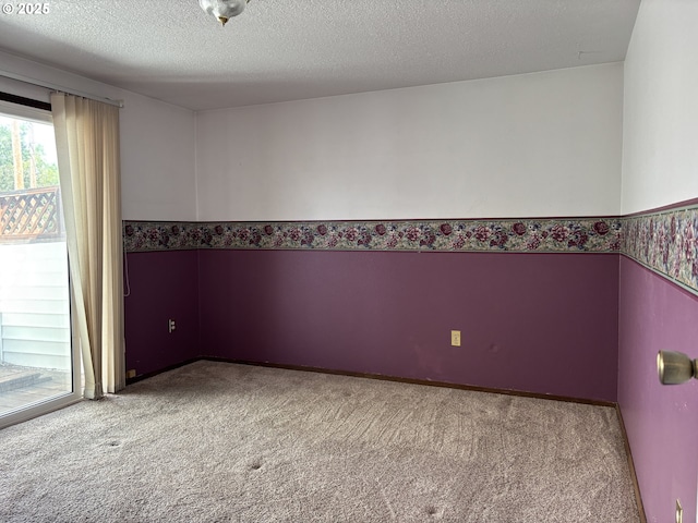 2312 N Pine St, La Grande, OR 97850 - spare room featuring carpet, a wainscoted wall, and a textured ceiling