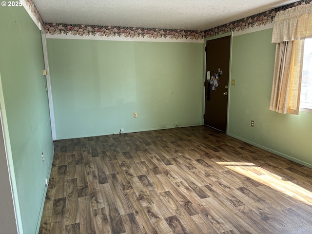 2312 N Pine St, La Grande, OR 97850 - spare room featuring wood finished floors and a textured ceiling