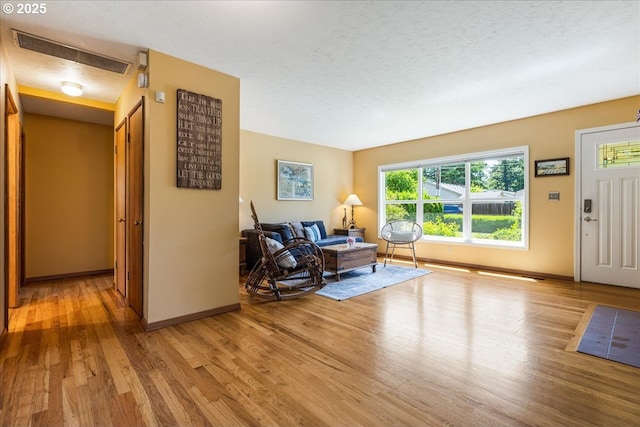 5570 SW Franklin Ave, Beaverton, OR 97005 - foyer entrance with light wood finished floors, baseboards, and a textured ceiling