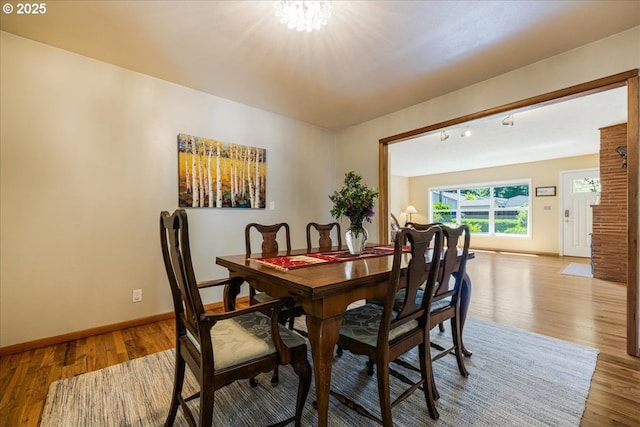 5570 SW Franklin Ave, Beaverton, OR 97005 - dining area featuring baseboards, wood finished floors, and a chandelier