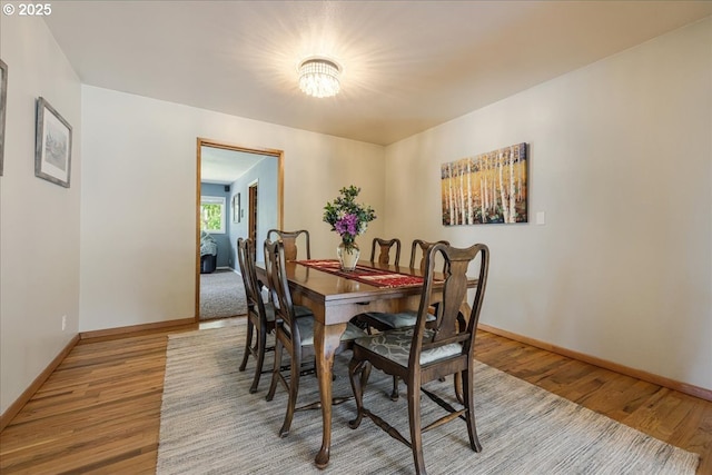 5570 SW Franklin Ave, Beaverton, OR 97005 - dining room featuring wood finished floors, baseboards, and a chandelier