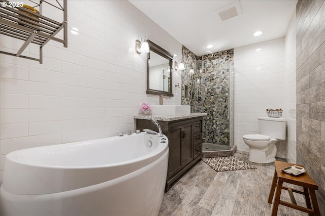 5570 SW Franklin Ave, Beaverton, OR 97005 - bathroom with tile walls, toilet, vanity, a shower stall, and wood finished floors