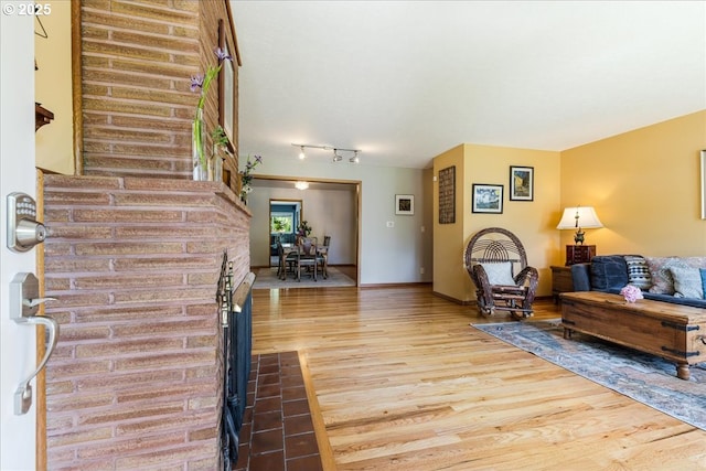 5570 SW Franklin Ave, Beaverton, OR 97005 - living room featuring wood finished floors, rail lighting, and baseboards