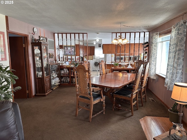 309 E Van Buren St, Athena, OR 97813 - dining room with washer / clothes dryer, a textured ceiling, carpet, and a chandelier