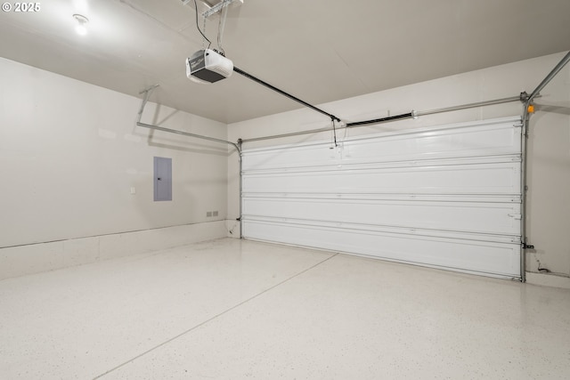 garage with a garage door opener and electric panel