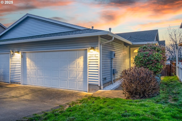 property exterior at dusk with a garage