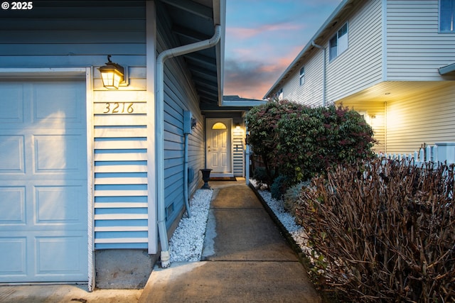 exterior entry at dusk with a garage