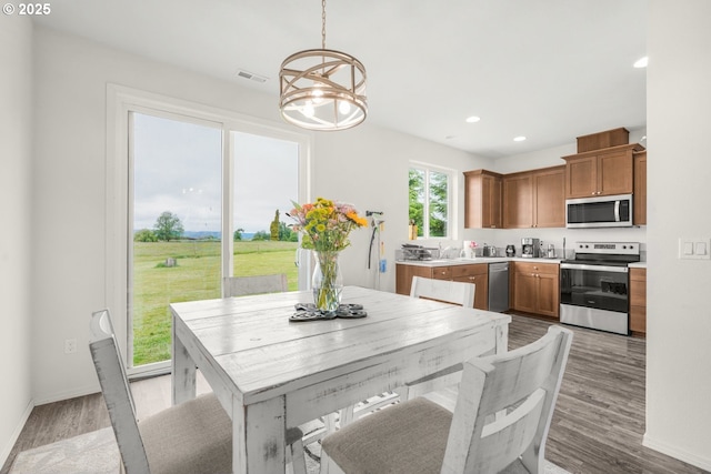 18385 Inglis Rd, Clatskanie, OR 97016 - dining room featuring a chandelier, light wood-style floors, recessed lighting, and baseboards