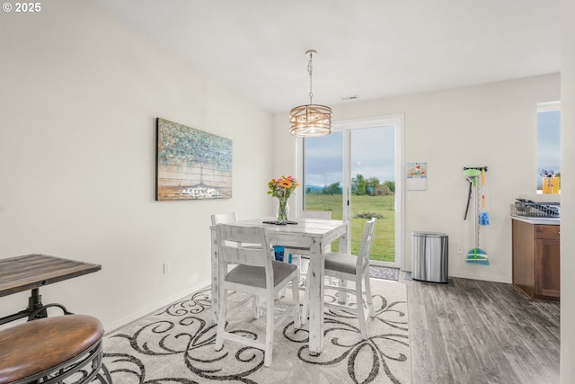 18385 Inglis Rd, Clatskanie, OR 97016 - dining room with a chandelier, light wood finished floors, and baseboards