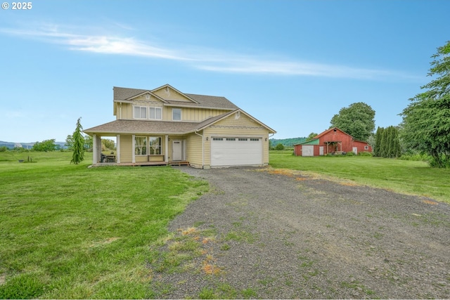18385 Inglis Rd, Clatskanie, OR 97016 - view of front facade with a garage, a front yard, covered porch, driveway, and board and batten siding