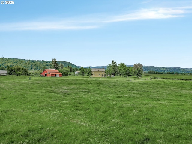 18385 Inglis Rd, Clatskanie, OR 97016 - view of grassy yard featuring a view of rural / pastoral area, a mountain view, and an outbuilding