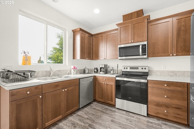 18385 Inglis Rd, Clatskanie, OR 97016 - kitchen with appliances with stainless steel finishes, a sink, light countertops, light wood-type flooring, and recessed lighting