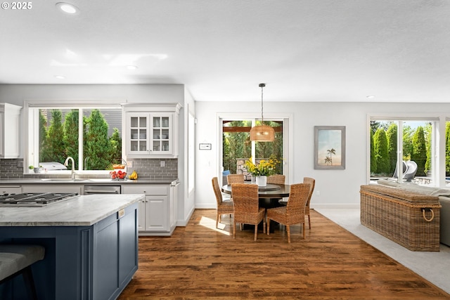 kitchen featuring stainless steel gas stovetop, healthy amount of natural light, a sink, white cabinets, and recessed lighting
