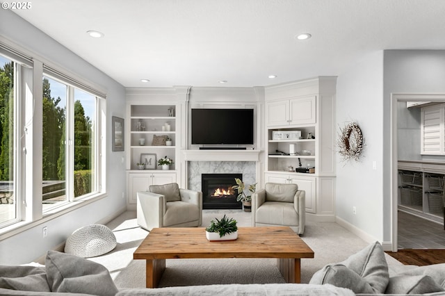 living area with a premium fireplace, recessed lighting, and baseboards