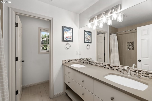 bathroom featuring double vanity, a shower with curtain, and baseboards