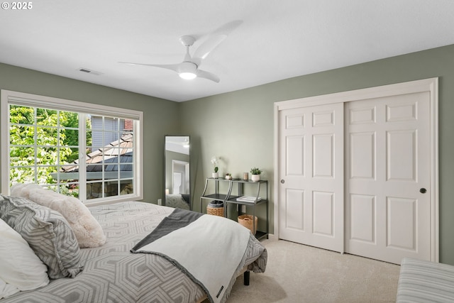 bedroom with carpet floors, a closet, and ceiling fan