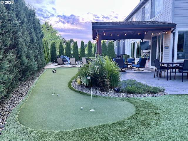 surrounding community with an area to practice putting and a patio area