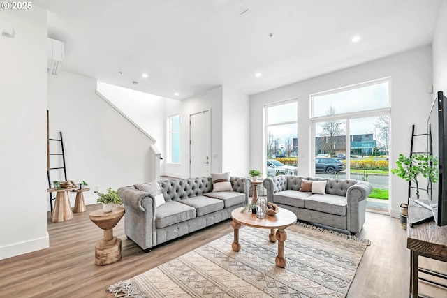 living room with a wealth of natural light and light wood-type flooring